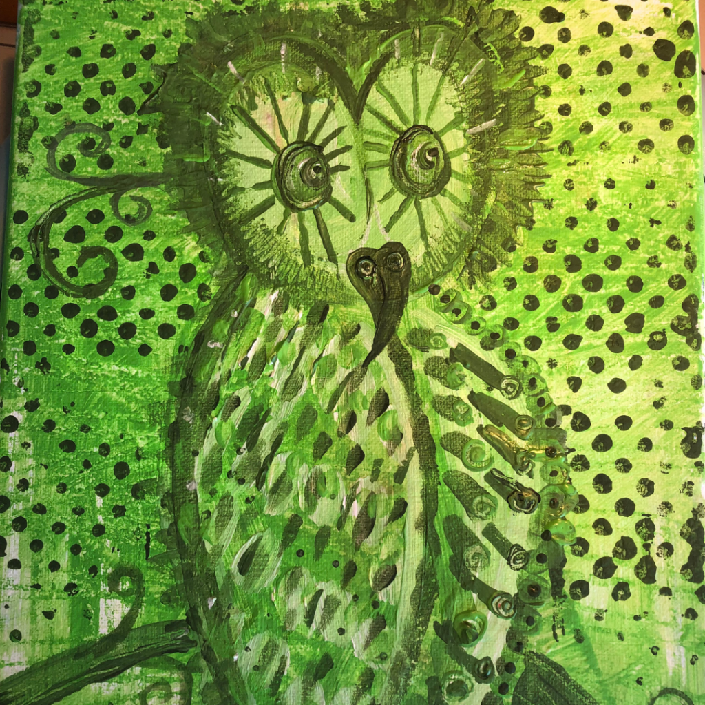 A wide eyed owl in hues ranging from deep green to lime with decorative geometric patterns