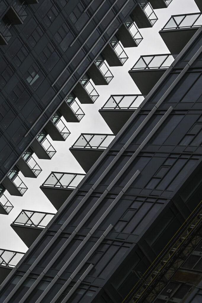 A geometric diagonal view of balconies before a grey sky in downtown New West